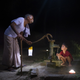 Guru Deen Shukla, is a retired 75-year-old state government worker. He pumps water for his grandson outside of his home in Pevre Badhai, India.